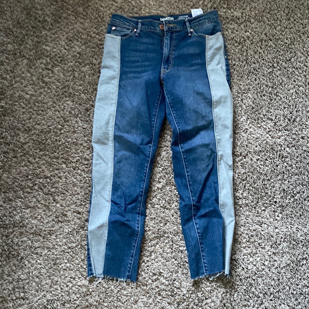 Dark color jeans with a light stripe on the side.